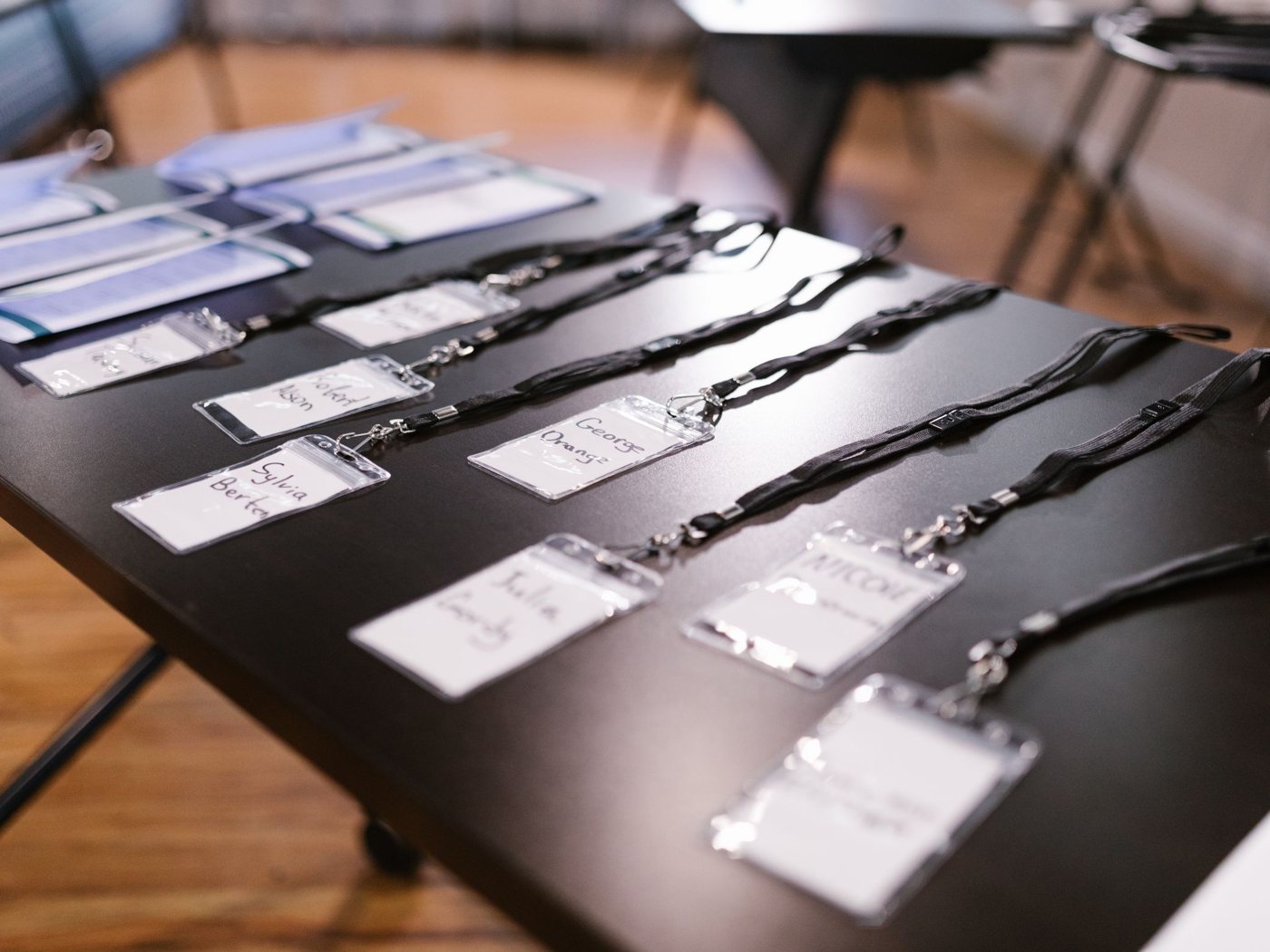 Identity badges on lanyards laid out on a table
